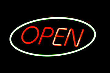 'OPEN' neon sign on black background 