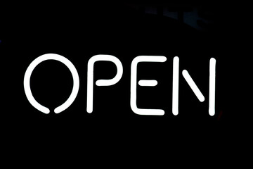 'OPEN' neon sign on black background 