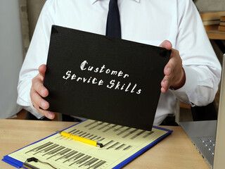 Business concept meaning Customer Service Skills with sign on the sheet.