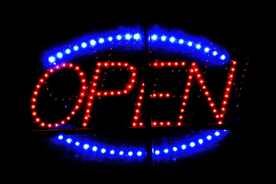 'OPEN' neon sign on black background
