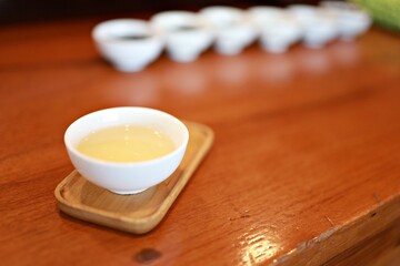 Tea time. Green tea cup  on the white desk.