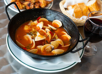 Gourmet seafood tapas. Delicious molluscs stewed in gravy with vegetables..
