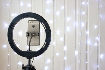 ring lamp and a smartphone on a tripod