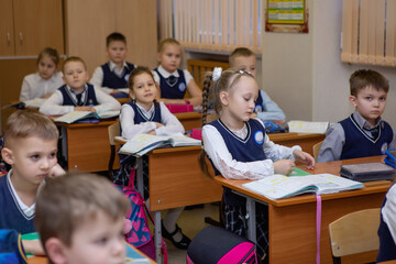 Pupils at desks in class on lesson