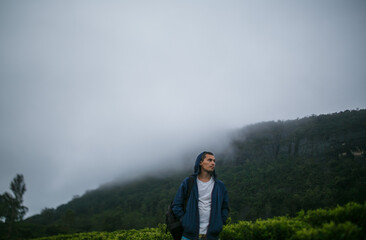 Tourist in the mountains against the background of fog.