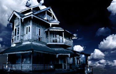Haunted house. Old abandoned house on night sky background