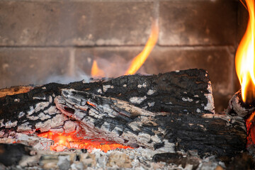flaming fire in an extinguished stone fireplace, horizontal