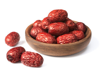 dried red dates in the wooden bowl, isolated on the white background