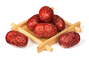 dried red dates in the wooden plate, isolated on the white background