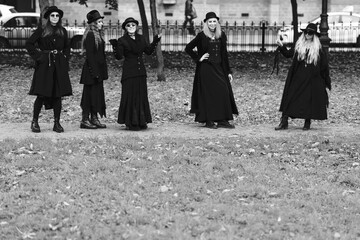 Fototapeta na wymiar Five women as witches go to the Sabbath, a group of witches or Goths