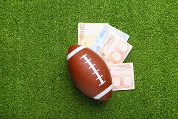 Money and rugby ball on color background. Concept of sports bet