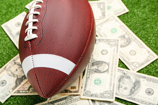 Money and rugby ball on color background, closeup. Concept of sports bet