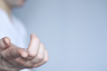 The concept of poor vision. Hold a contact lens and glasses in hand. A poster for advertising...