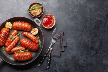 Hot grilled sausages in a frying pan