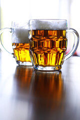 Glass of fresh beer on a wooden table. Lager beer mug on stone table. Top view with copy space
