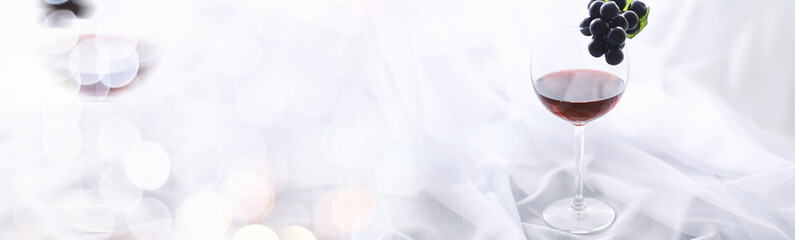 Glass with grape red semi-dry wine. Valentine's day concept background. Gift for the holiday. Sweet sparkling wine.