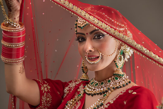 Beautiful Indian Bride holding a veil	