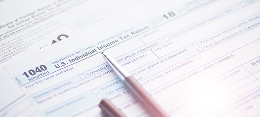 Annual tax reporting. Tax form on the table. Financial statements for signature.