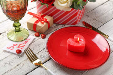 Festive table setting for Valentines Day celebration on white wooden background