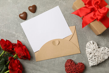 Concept of Valentines day with empty envelope on gray background
