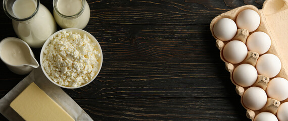 Different fresh dairy products on wooden background, space for text