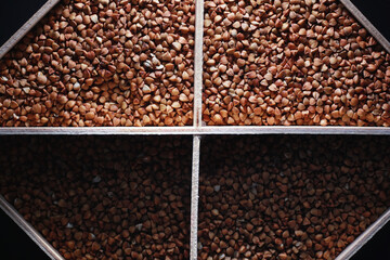 A set of grain cereals. Rice, buckwheat and millet groats in a wooden tray. A grocery set of...