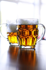 Glass of fresh beer on a wooden table. Lager beer mug on stone table. Top view with copy space