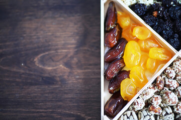 Nuts and dried fruits assortment on stone table top view.