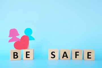 Pink and blue human icon cutout with red distance marker. Social distancing on Valentine's Day celebration during covid-19 pandemic concept.