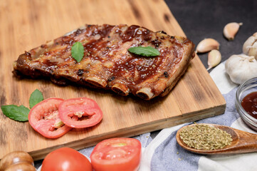 Homemade Barbecue spare ribs with BBQ marinade and dipping sauce. Cooking at home on winter holiday.
