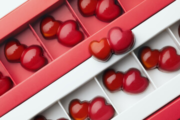 Naklejka na ściany i meble Craft dark chocolate candies in a double red double heart shape in boxes. Pattern. Sweet gift for valentines day