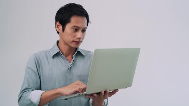 A man checking the name list on the Internet. Men are very crazy when they find the award. Men use the Internet on their computers reducing time to find information. concept of joy and success.