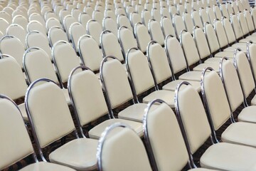 White chairs arranged neatly in pattern 