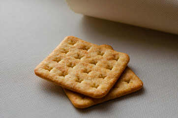 Square Salt Crackers on white textured background.