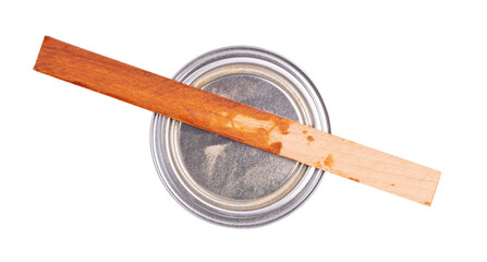 Old stirring stick with a pot of paint
