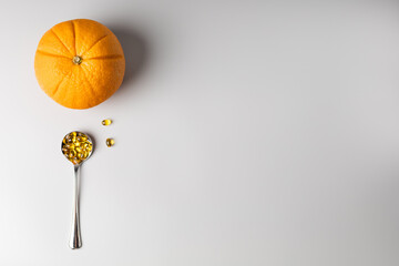 Orange and spoon with vitamin C