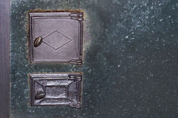 The doors of the old stove. Grey, the body is covered with a gray sheet of iron.