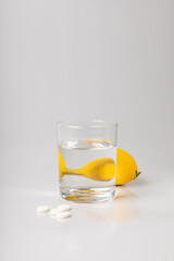 Lemon, a glass of water and medicine