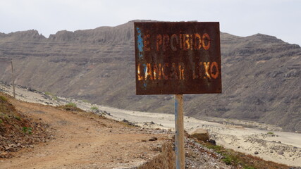 a sign on the hill in Salamansa, on the island Sao Vicente, Cabo Verde, in the month of December (translation: It is prohibited to throw away garbage)