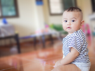 Portrait child little boy  6 months old with blur image. he smile happy. cute and authentic. baby thai concept.