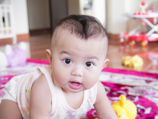 Fototapeta premium Portrait child little boy 6 months old with have have 2 teeth on blur image. he smile happy. cute and authentic. baby thai concept.