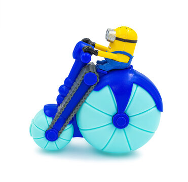 Plastic minion toy on blue bike sold as part of Mcdonald's Happy Meal