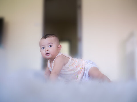 Blur and soft focus image of Portrait child little boy 6 months old on blur image. he smile happy. cute and authentic. baby thai concept.