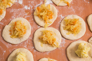 Small dough cakes are filled with fried cabbage. homemade baking