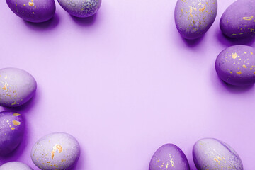 Easter frame of eggs painted in purple color. Flat lay, top view. Copy space for text.