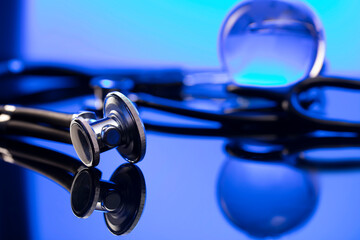 Global healthcare concept. Stethoscope on blue table and background.