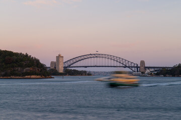 Boat travelling at Sydney Harbour at sunset time.
