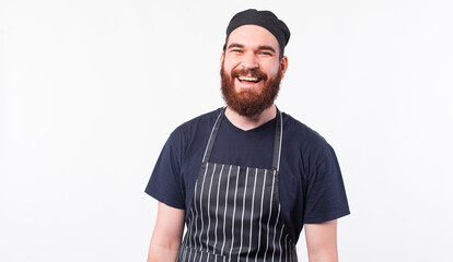 Portrait of smiling bearded chef man over white background.