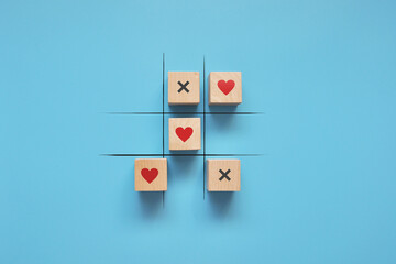 A game of tic-tac-toe with hearts and crosses. Valentine's Day greeting card. The victory of love...