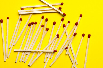 matches are piled on a yellow background close-up.